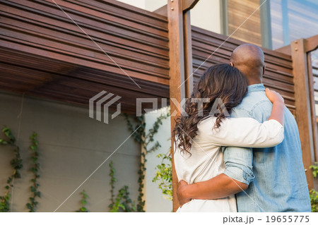 Couple with arms above after buying house 19655775