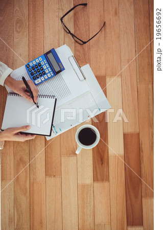 Cropped image of woman writing on notepad 19656692