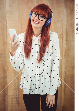Attractive hipster woman listening to music with headphones 19656996
