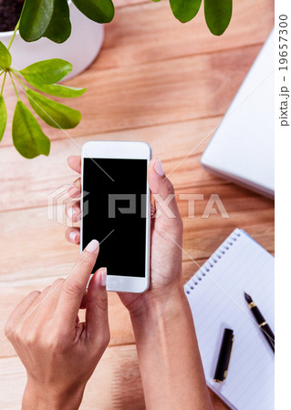 Overhead of feminine hands using smartphone 19657300