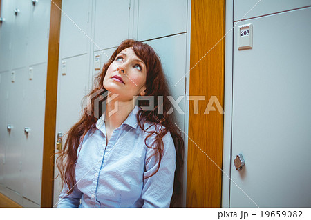 Mature student feeling stressed in hallway 19659082