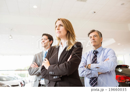 Group of smiling business team standing together 19660035