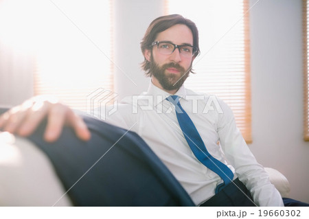Happy businessman sitting on couch Happy businessman sitting on couch 19660302