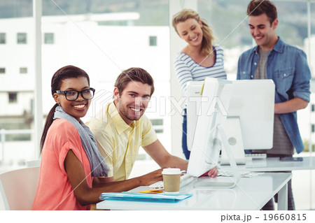 Creative business team working hard together on pc Creative business team working hard together on pc 19660815