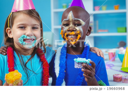 Smiling kids with icing on their faces Smiling kids with icing on their faces 19660968