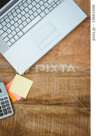 Business desk with laptop and calculator Business desk with laptop and calculator 19661006
