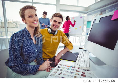 Graphic designer wearing headphones at desk Graphic designer wearing headphones at desk 19661280
