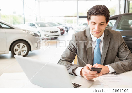 Smiling salesman having a phone call 19661506