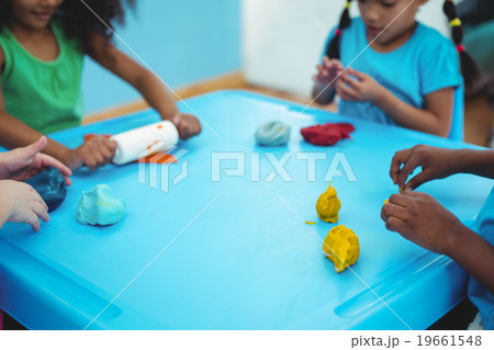 Smiling kids using modelling clay Smiling kids using modelling clay 19661548