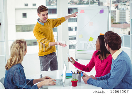 Creative businessman giving a presentation Creative businessman giving a presentation 19662507