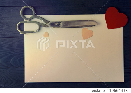 Hearts, sheet and scissors on dark background Hearts, sheet and scissors on dark background 19664433