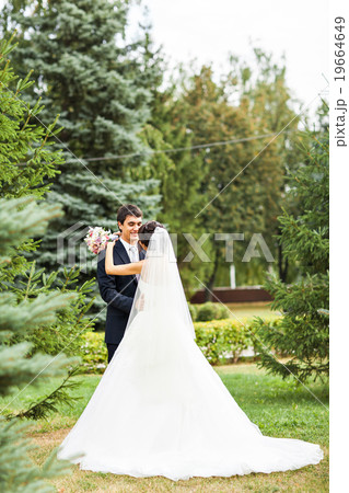 bride and groom kissing in park bride and groom kissing in park 19664649