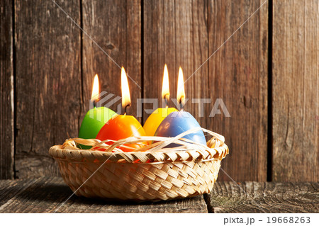 Easter candles on wooden table 19668263