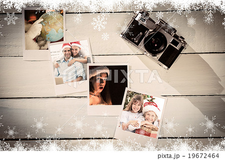 Composite image of happy couple in santa hats shopping online with laptop 19672464