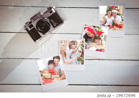Composite image of happy couple celebrating christmas at home Composite image of happy couple celebrating christmas at home 19672696