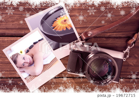 Composite image of glowing young woman with hot stone on her bac 19672715