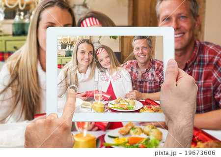 Composite image of hand holding tablet pc 19673606