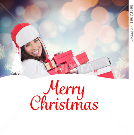 Composite image of festive brunette in winter clothes holding ma Composite image of festive brunette in winter clothes holding ma 19673999