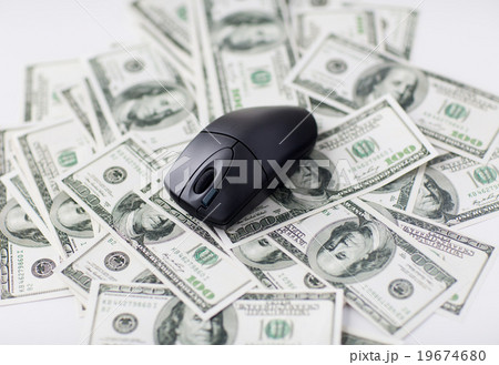 close up of computer mouse and dollar cash money close up of computer mouse and dollar cash money 19674680