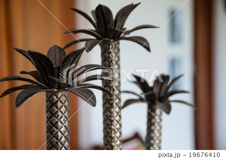 Small palm tree metal decoration on table 19676410