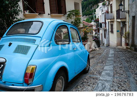 Small italian car on narrow road in village Scilla 19676783