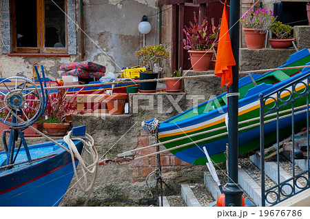 Two blue and green boats sitting on land in small 19676786