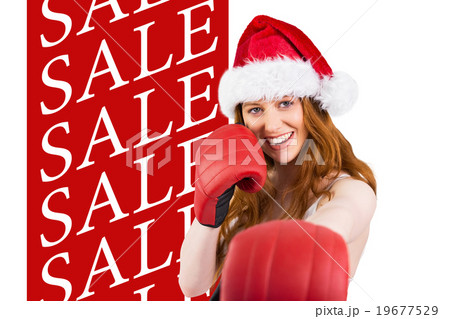 Composite image of festive redhead punching with boxing gloves 19677529