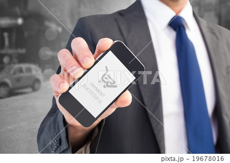Composite image of businessman showing his smartphone screen 19678016