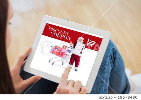 Composite image of teen using a tablet pc sitting on the floor Composite image of teen using a tablet pc sitting on the floor 19678480