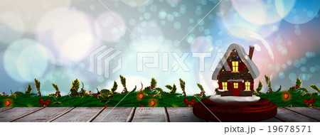 Composite image of christmas cottage in snow globe Composite image of christmas cottage in snow globe 19678571