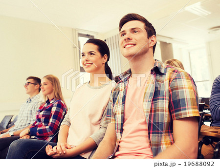 group of smiling students in lecture hall group of smiling students in lecture hall 19688092