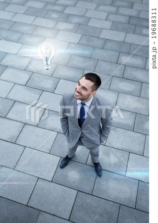 young smiling businessman outdoors from top young smiling businessman outdoors from top 19688311