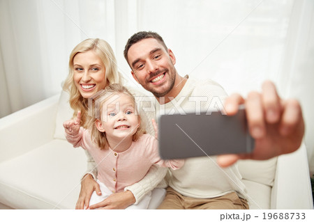 family taking selfie with smartphone at home 19688733