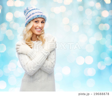 smiling young woman in winter hat and sweater 19688878