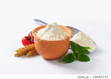Wheat flour in terracotta dish and metal scoop 19690153