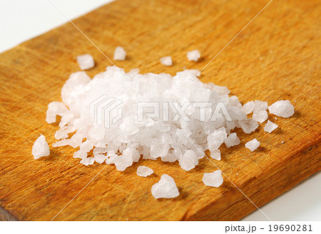 Coarse sea salt on cutting board 19690281