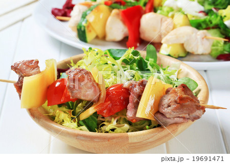 Grilled pork skewer and spring salad Grilled pork skewer and spring salad 19691471