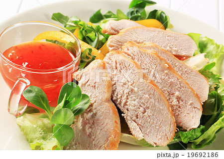 Sliced chicken breast with salad and sweet chilli sauce Sliced chicken breast with salad and sweet chilli sauce 19692186