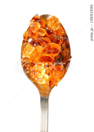 Brown rock sugar on spoon Brown rock sugar on spoon 19692690
