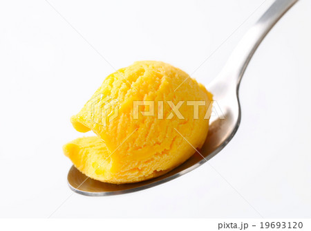 Yellow ice cream on a spoon 19693120