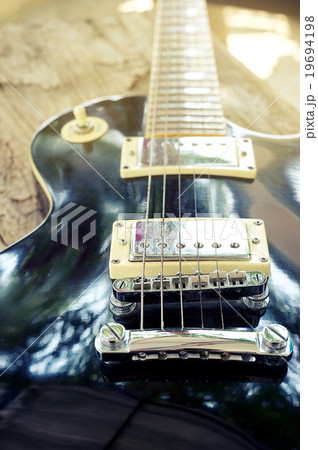 Grungy Electric guitar on wood and vintage effect  19694198