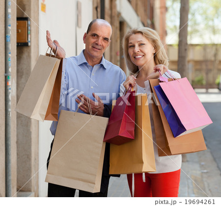Aged couple with purchases 19694261