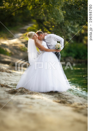 Cheerful married couple standing on the beach Cheerful married couple standing on the beach 19698780