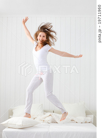 happy girl jumping and having fun in bed happy girl jumping and having fun in bed 19711960