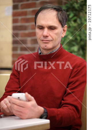 Mature man with smartphone Mature man with smartphone 19712175