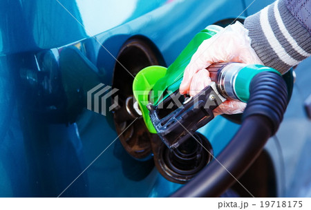 man pumping gasoline fuel in car at gas station man pumping gasoline fuel in car at gas station 19718175