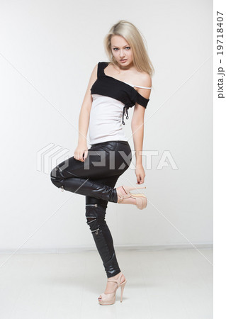 Beautiful girl in black leather pants.  19718407
