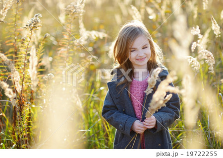 Portrait of a cute little girl on autunm day Portrait of a cute little girl on autunm day 19722255