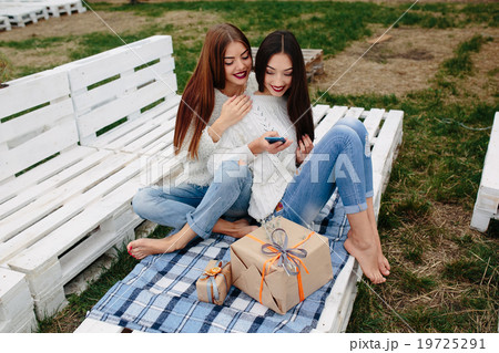 Two girls make selfie with gifts 19725291