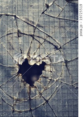 Filtered hole in broken security glass Filtered hole in broken security glass 19725519